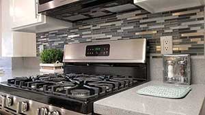 Close up of kitchen stove and back splash