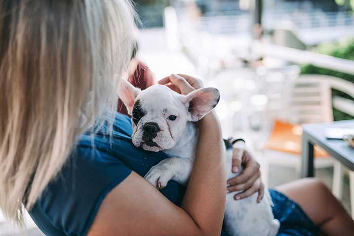 Woman holding her puppy